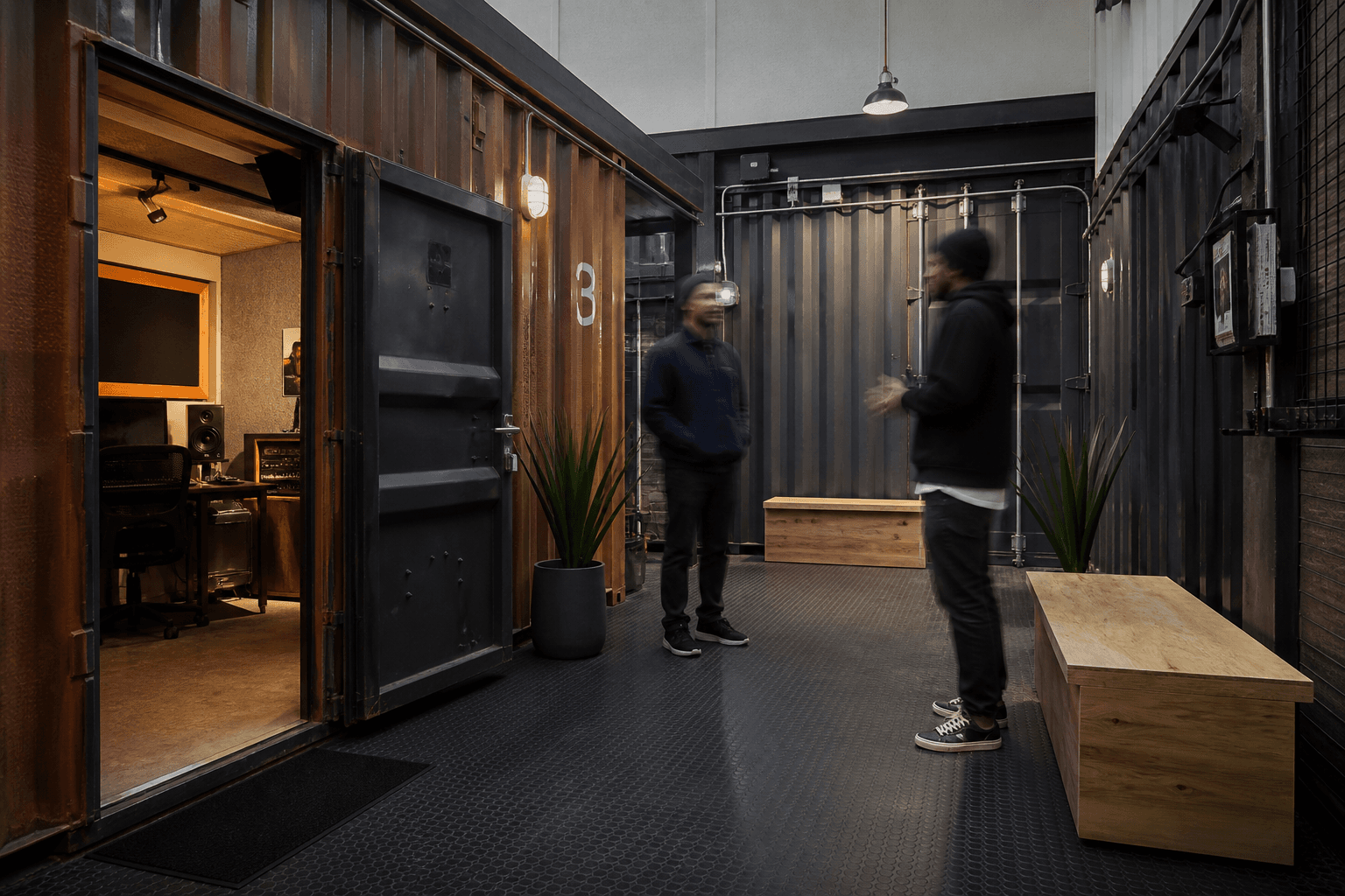 Shared lounge between shipping-container studio booths